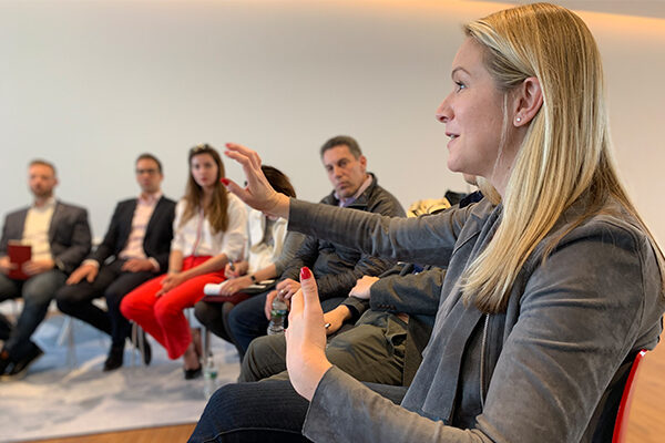 A woman talks with her hands at the Strategic Product Marketing Trek.