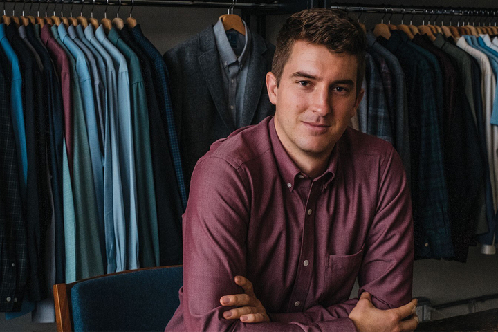 Image of Mac Bishop in front of his clothing line made out of merino wool