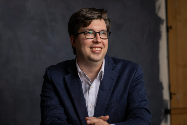 Headshot of a seated man wearing a suit jacket.