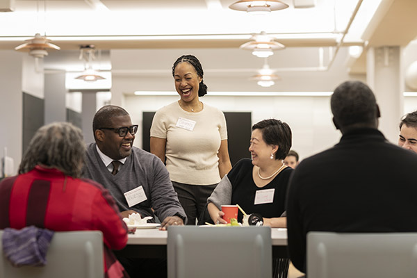 A group of professional men and women engaged in conversation